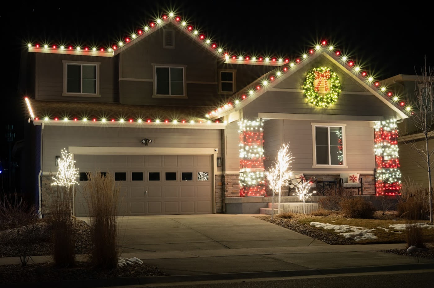 Home with professionally installed seasonal Christmas roofline and column lights